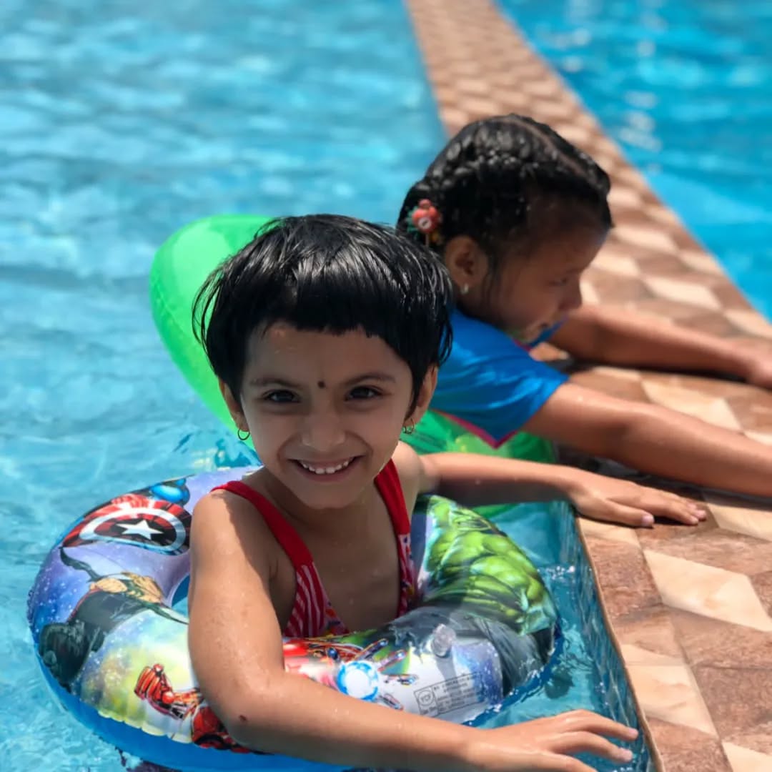 Children with floaties at pool edge